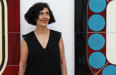 Artist Lubna Chowdhary stood in front of artwork