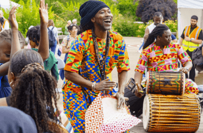 A group of drummers plays for a crowd at the Great Get Together