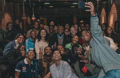 A group of people pose for a selfie