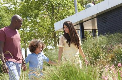 A family walk hand-in-hand in queen elizabeth olympic park