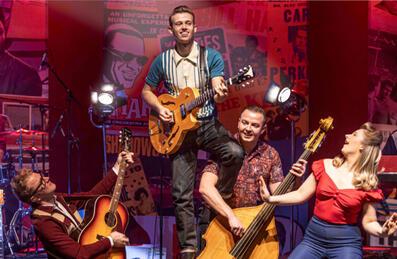 A rock and roll band play on stage