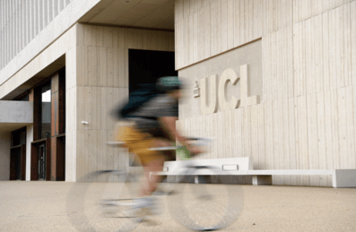 Cyclist passing in front of UCL Marshgate