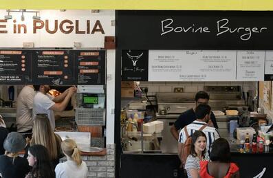 People queueing for food from vendors at Hackney Bridge