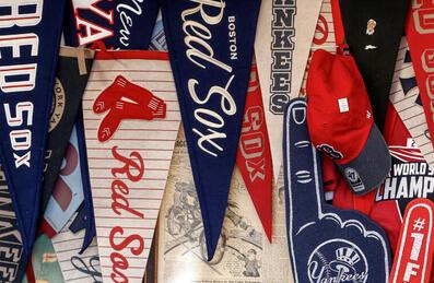 Flags from large MLB teams, displayed on a wall