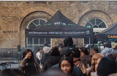 Food retailers and crowd at Black Eats