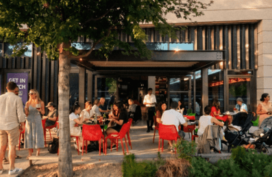 A restaurant's outdoor dining terrace filled with patrons