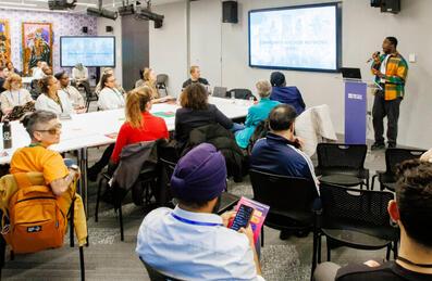 Community Anchor Network discussion with speaker and group listening