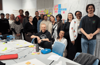 A diverse group of people smiling in an office room