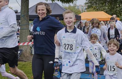 A group of people of different ages start the Cure EB Run