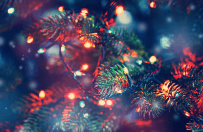 A close up of a Christmas tree with lights decorating it