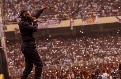 Ferre Gola performing on stage in front of a large crowd
