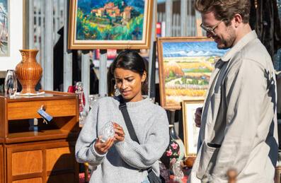 Two people look at an item at the Giant London Flea Market