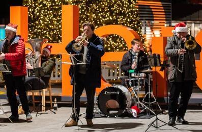 A band plays on stage at Here East canalside Christmas event