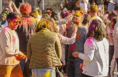 People celebrate Holi with bright colours on their faces