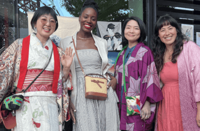 A group of women smiling at a market
