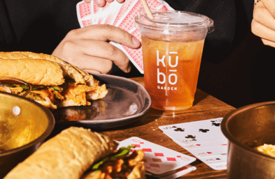 People playing cards whilst eating and drinking