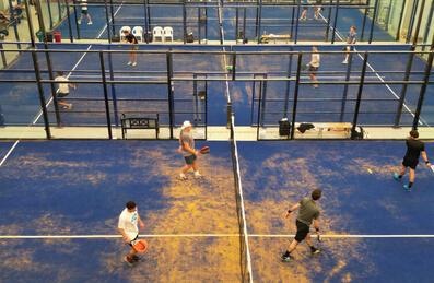 A series of Padel courts at Padel Stratford with players on them
