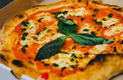 A pizza in a takeaway box