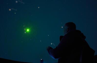 A person enjoys a planetarium