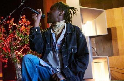 A performer on stage at Queer Edge