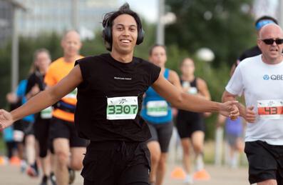 a runner with their arms out as part of a runthrough event