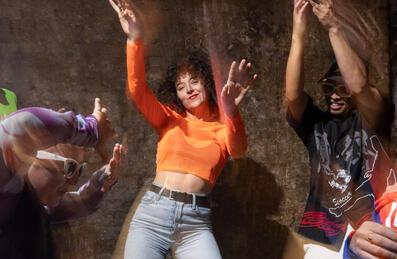 Dancer's in bright clothes performing in a blurry photo