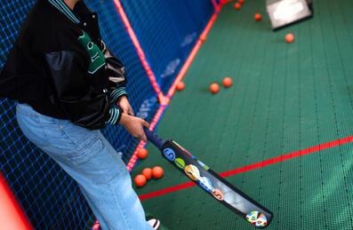 A person holds a cricket bat