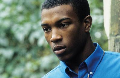 A young man stares off screen