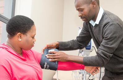 a man fits a blood pressure device to a person