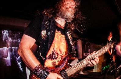 A man plays a guitar on stage