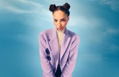 A person stands in the middle of a blue background