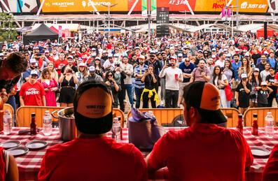 A crowd at Wing Fest with people on stage