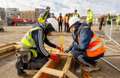 Photos of two builders levelling some wood