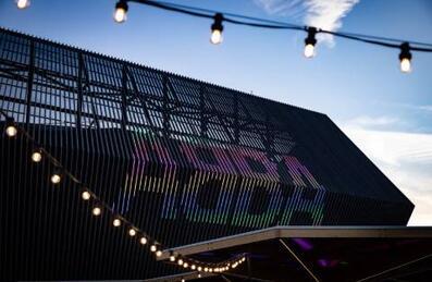 ABBA Arena on Queen Elizabeth Olympic Park shot from outside at dusk with fairy lights in the foreground