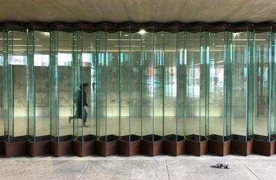 Person walking behind perspex at Hackney Wick Station