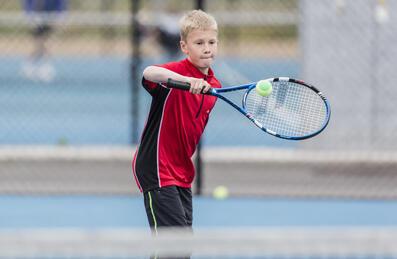 Boy playing tennis