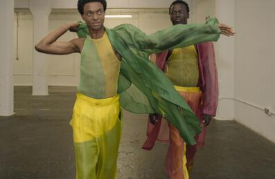 Two models wearing bright clothes at LCF Postgrad showcase