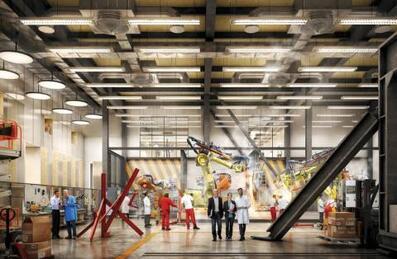 People walking in a large warehouse being used for robotics development by UCL at Here East