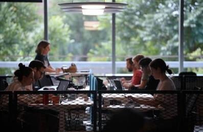 People working on hot desks at Plexal