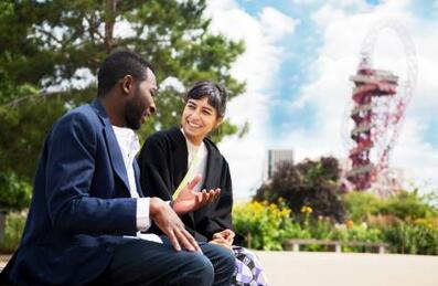 Two people talking at the Park with the ArcelorMittal Orbit in the background