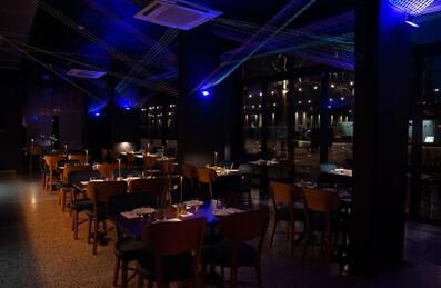 A photo of Bamboo Mat's moody interior with blue lighting