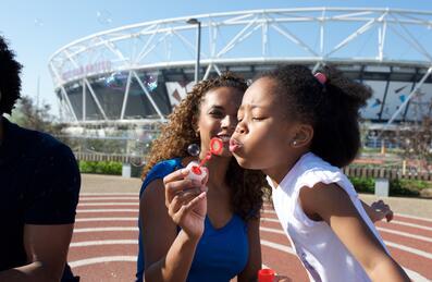 mother and dughter blowing bubbles