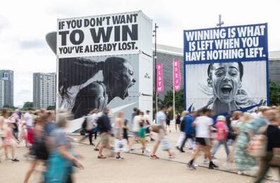 Photo of people walking past the Nike brand activation on Queen Elizabeth Olympic Park