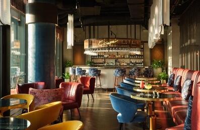 A cocktail bar with multicoloured art deco seating