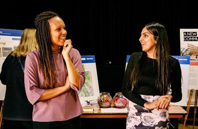 Two women chatting at a community event