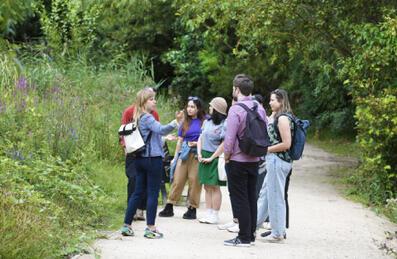 a group of people take a tour through Queen Elizabeth Olympic Park