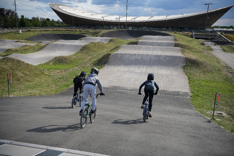 three people cycling at the BMX park 