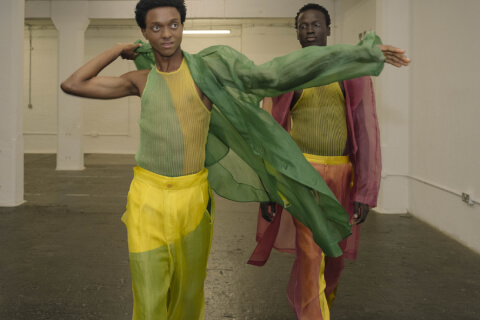 Two models wearing bright clothes at LCF Postgrad showcase