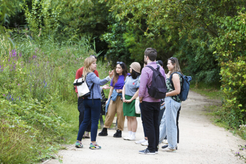 a group of people take a tour through Queen Elizabeth Olympic Park